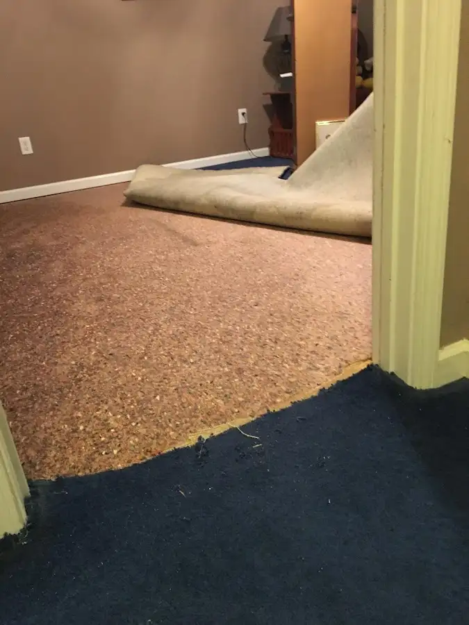 Carpet pad removal revealing water damage during Water Mitigation Services in South Gate